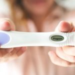 woman-holding-a-pregnancy-test-indicating-that-she-is-pregnant