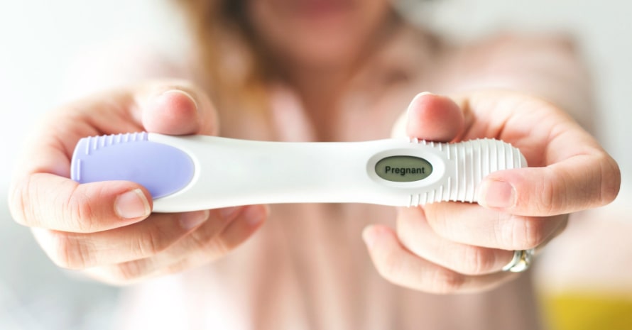 woman-holding-a-pregnancy-test-indicating-that-she-is-pregnant