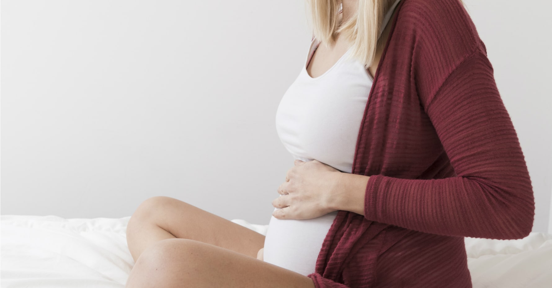 pregnant woman touching her stomach