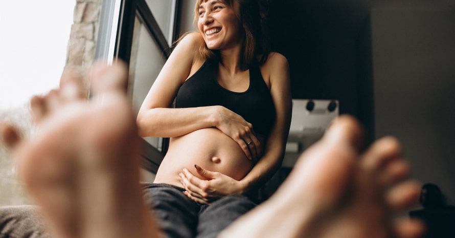 pregnant-woman-sitting-by-window