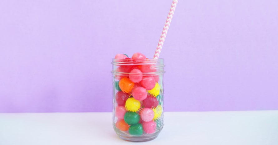 Glass of multi-colored gummies