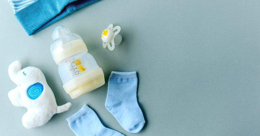 baby goods and milk in the baby bottle