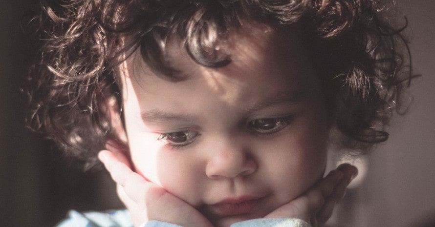 child with brown curly hair